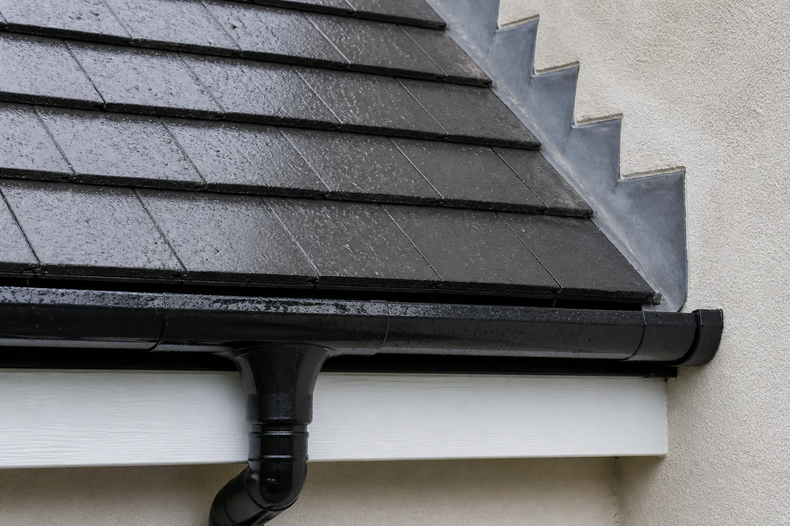 Illustrative tight detail of straight wet roof tiles, stepped flashing, eaves and gutter
